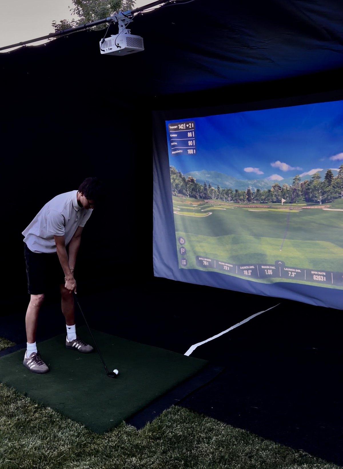 A TILT golf simulator set up at a corporate event
