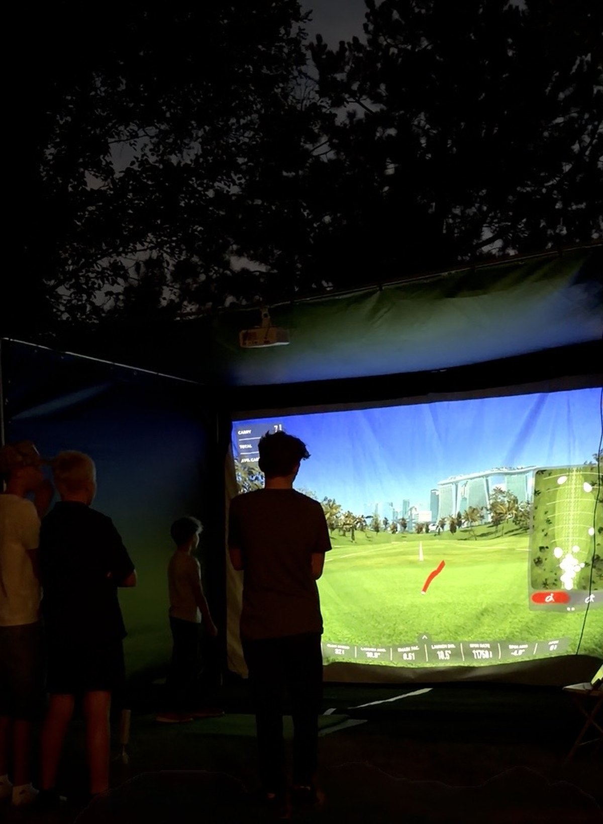 A TILT golf simulator set up at a private party